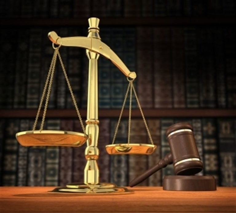 A 3D render of a judge's gavel and scales representing justice