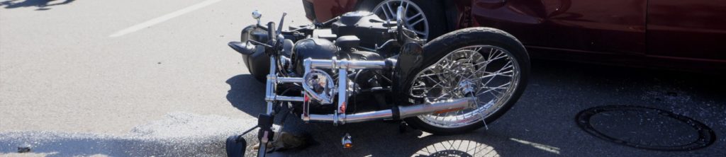 Motorcycle laying on the ground after motorcycle accident