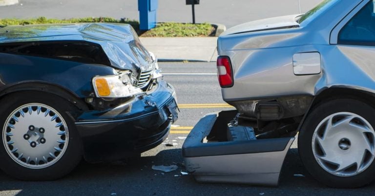 Silver car rear ended in auto accident by a green car