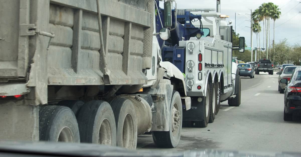 Two construction trucks driving in Florida