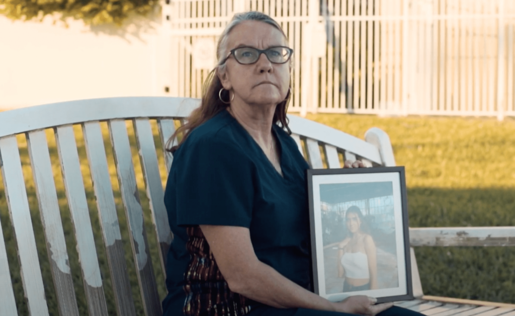 woman holding photo of lost one