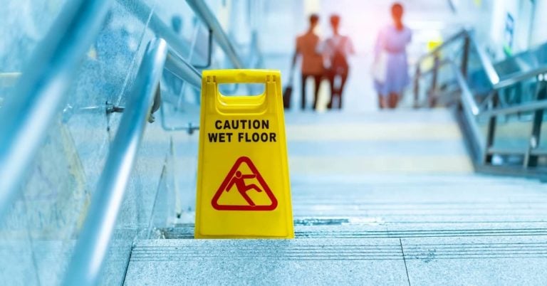 caution wet floor sign on the steps of a building