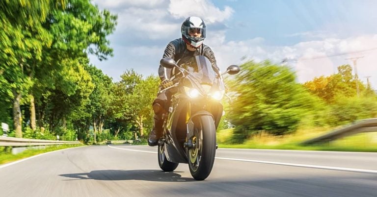 Man with helmet riding Motorcycle on highway