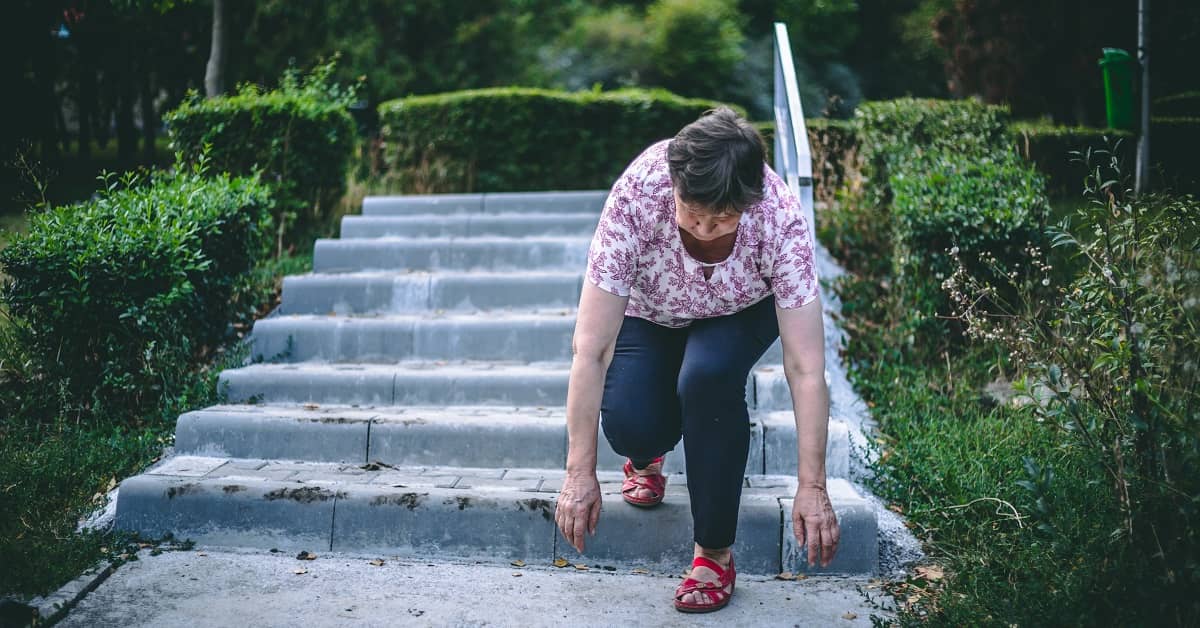 Elderly woman slipping and falling down steps