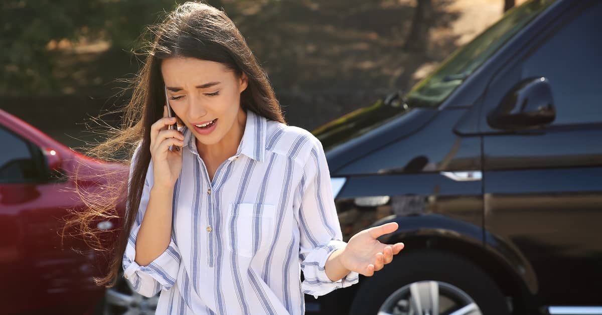 Women on cell phone in front of an car accident
