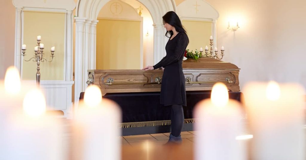 Women in black at a funeral in a chapel