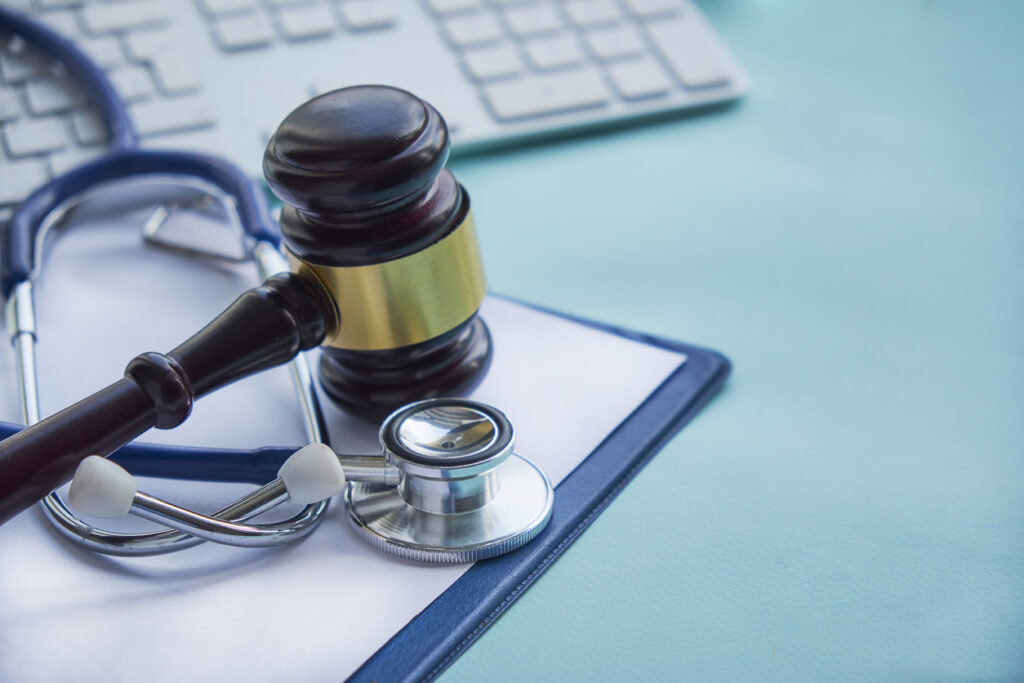 Gavel and stethoscope on a patient's medical chart