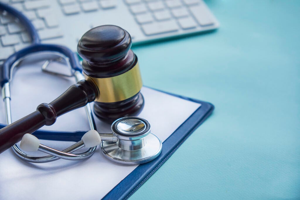 A gavel and stethoscope on a desk