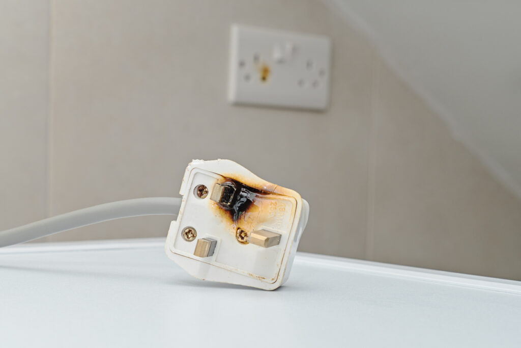 A scorched and burned power cord from a defective product