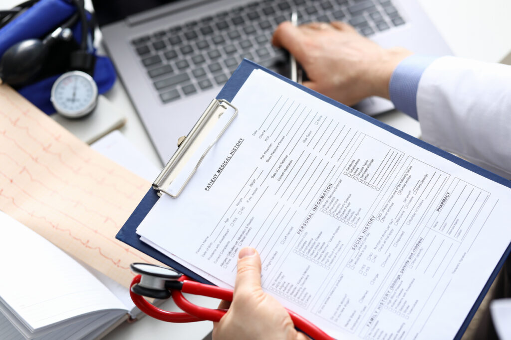 Doctor holding clipboard with medical records