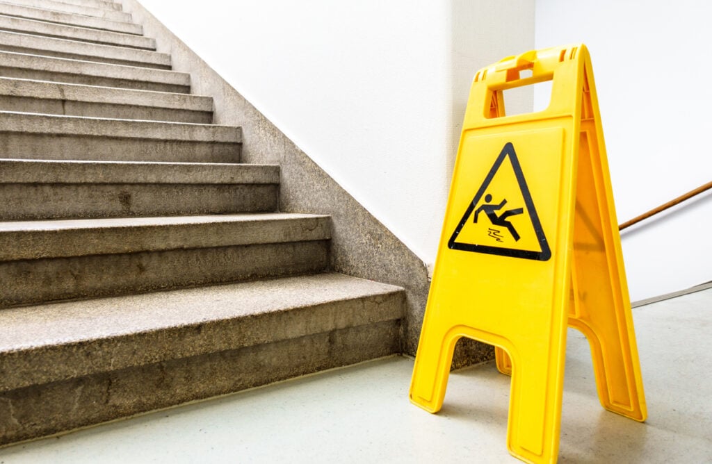 "Caution: Wet Floor" sign at the bottom of the stairs