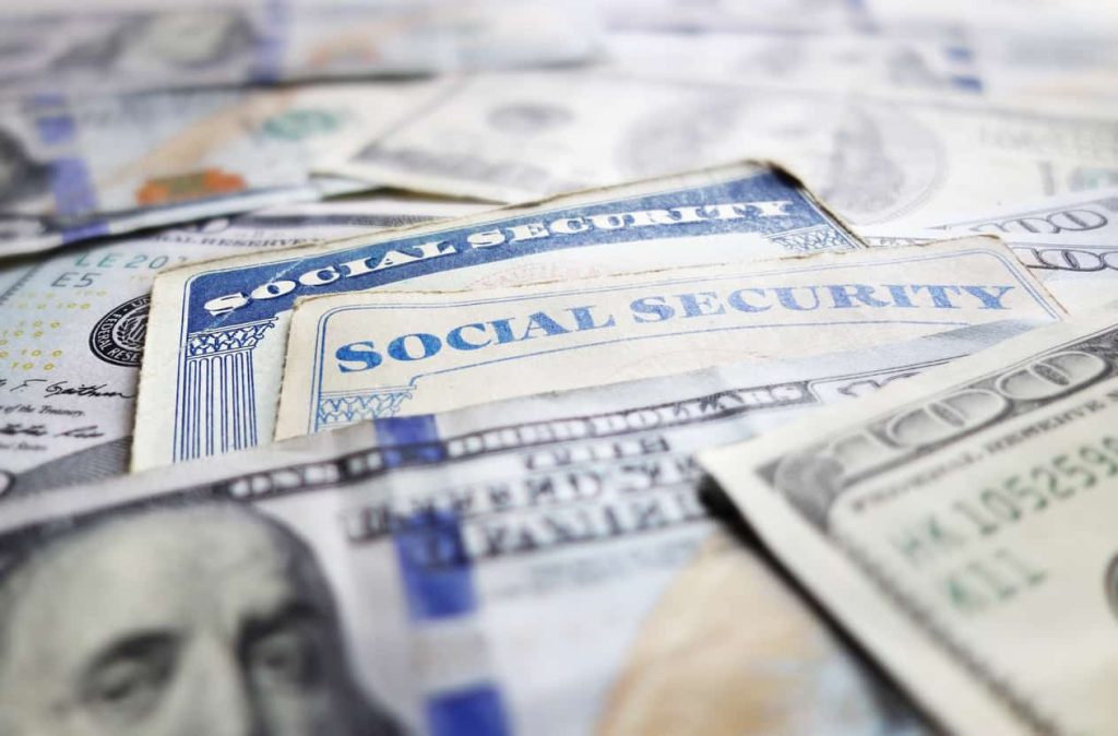 Social security cards and money laid in a pile