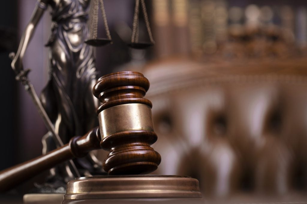 A gavel on a judge's bench with a leather chair in the background