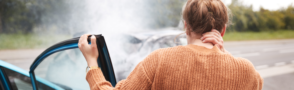 Vignette of woman rubbing her neck after a car accident