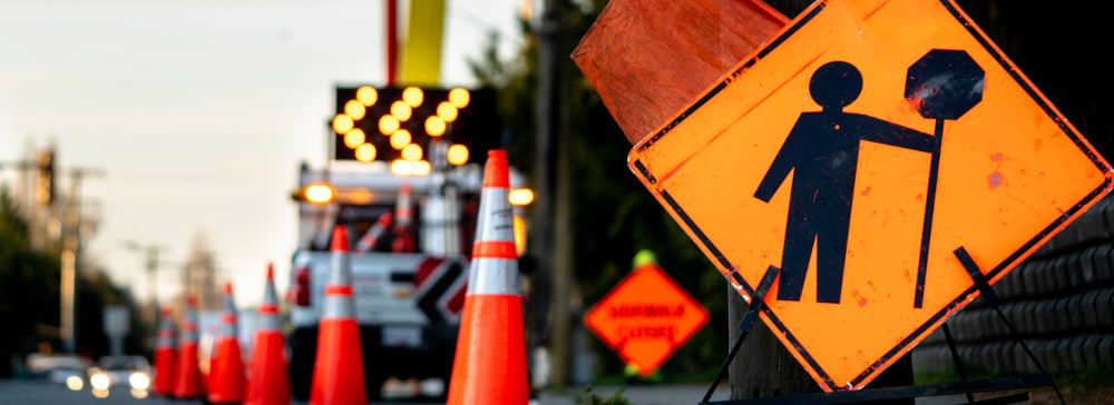 Construction zone signs on a busy city street