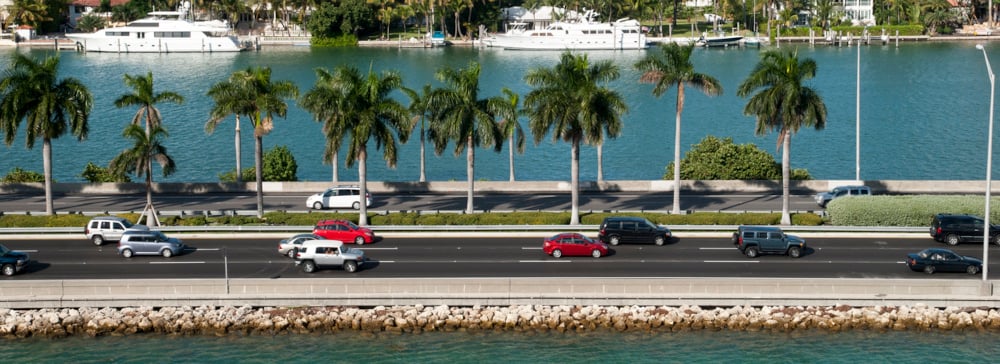 Cars crossing a causeway in Florida with boats in the background