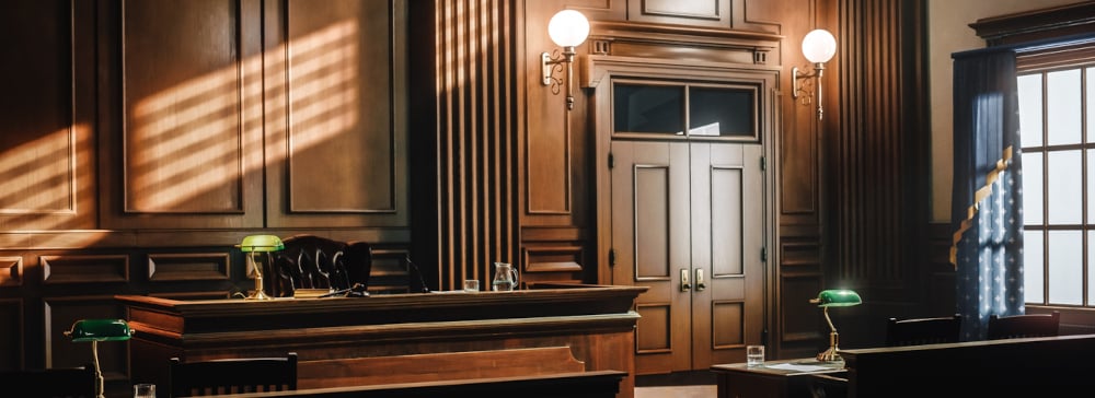 An empty courtroom facing the judge's bench