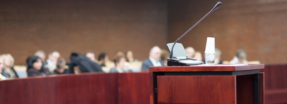 Witness stand podium with a microphone in a court room