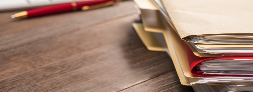 Vignette of a stack of file folders on a desk