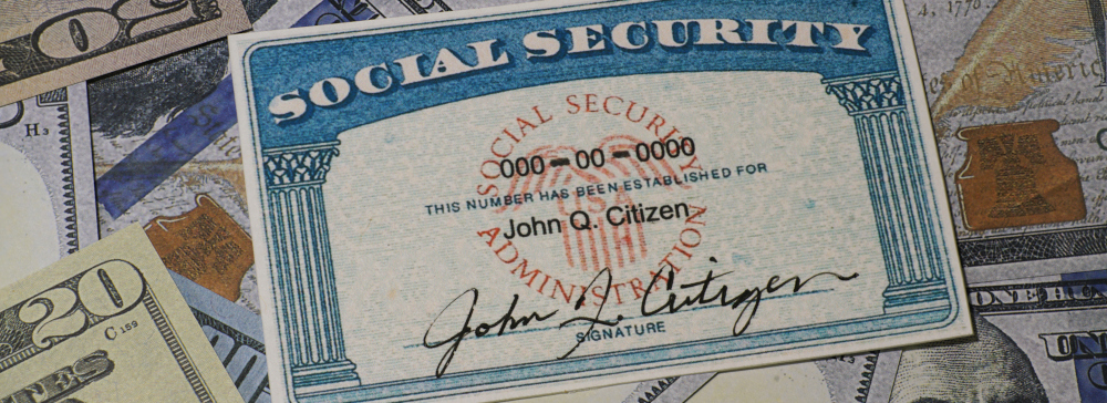 An example social security card on top of dollar bills