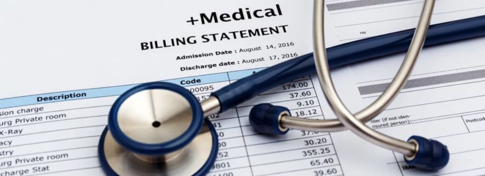 A printed medical billing statement with a stethoscope on top of it