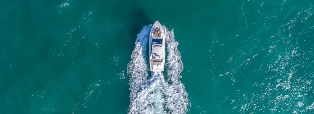 An aerial view of a boat sailing off the coast of Florida