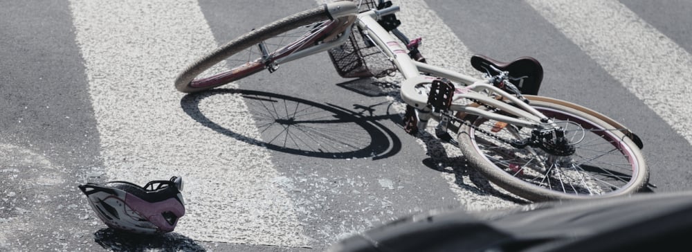 Helmet next to bike on crosswalk after a bike accident