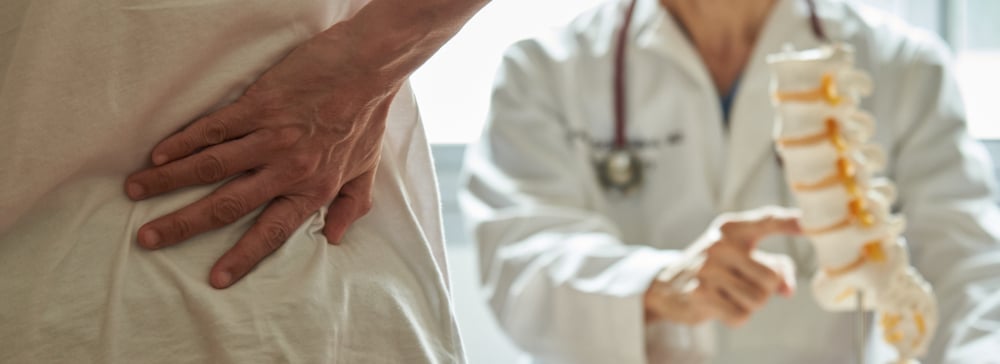 A doctor explaining lumbar anatomy to a spinal cord injury patient