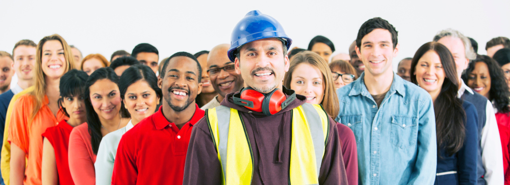 A group of different types of workers looking into the camera