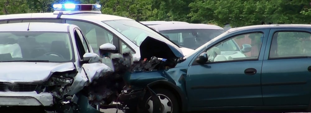 A three-car accident with an emergency services vehicle behind