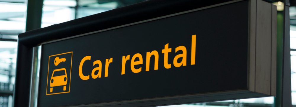 A car rental direction sign in an airport