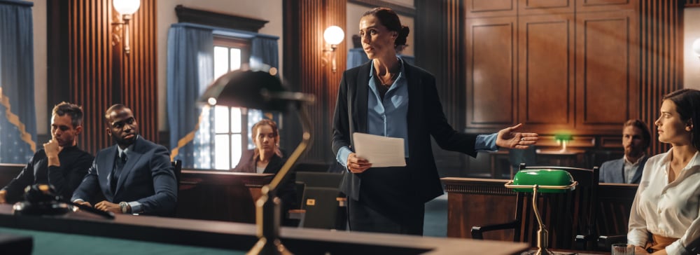 Female defense attorney in courtroom presenting a case