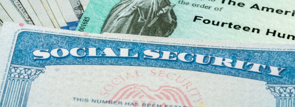 A blank social security card on top of a US government check
