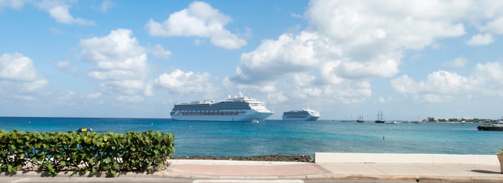 A view from the waterside of cruise ships in the distance