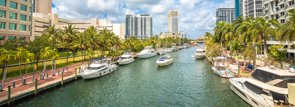 Fort Lauderdale riverwalk with boats lined up along the waterside