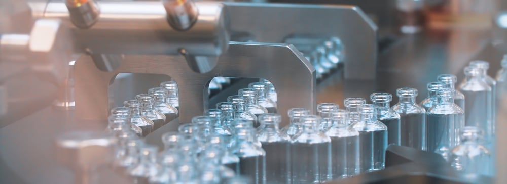 Glass bottles on a pharmaceutical factory machine