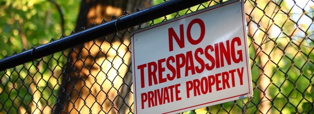 No trespassing private property sign on a fence