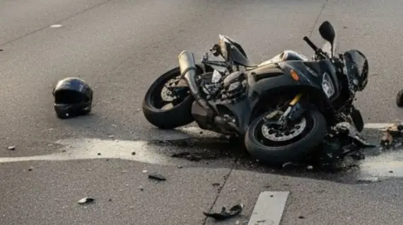 A motorcycle accident scene on a busy Fort Myers road