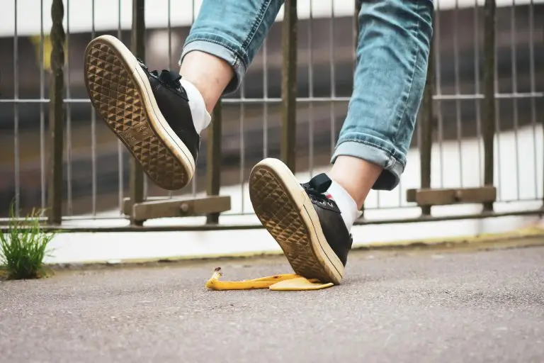 Person slipping on a banana peel on a sidewalk, illustrating the potential timeline and legal process of a Florida personal injury lawsuit.